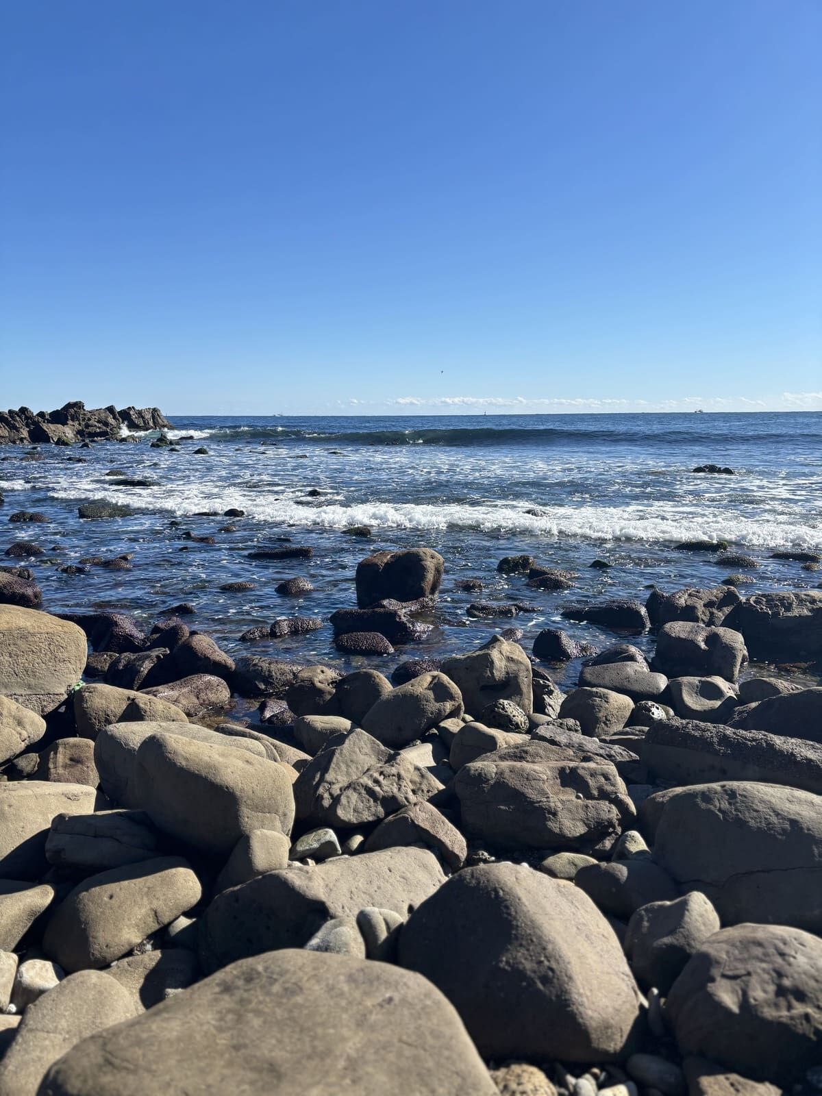 岩が積み重なる磯崎海岸の浜